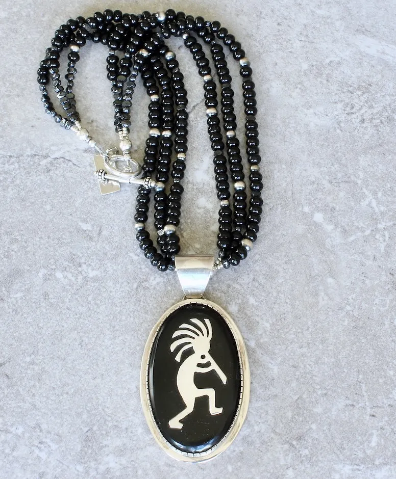 Indonesian Palmwood and Sterling Silver Kokopelli Pendant with 3 Strands of Onyx Rondelles, Vintage Czech Nailheads, Oxidized Sterling Silver Rounds and a Sterling Silver Toggle Clasp