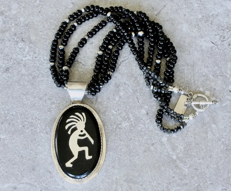 Indonesian Palmwood and Sterling Silver Kokopelli Pendant with 3 Strands of Onyx Rondelles, Vintage Czech Nailheads, Oxidized Sterling Silver Rounds and a Sterling Silver Toggle Clasp